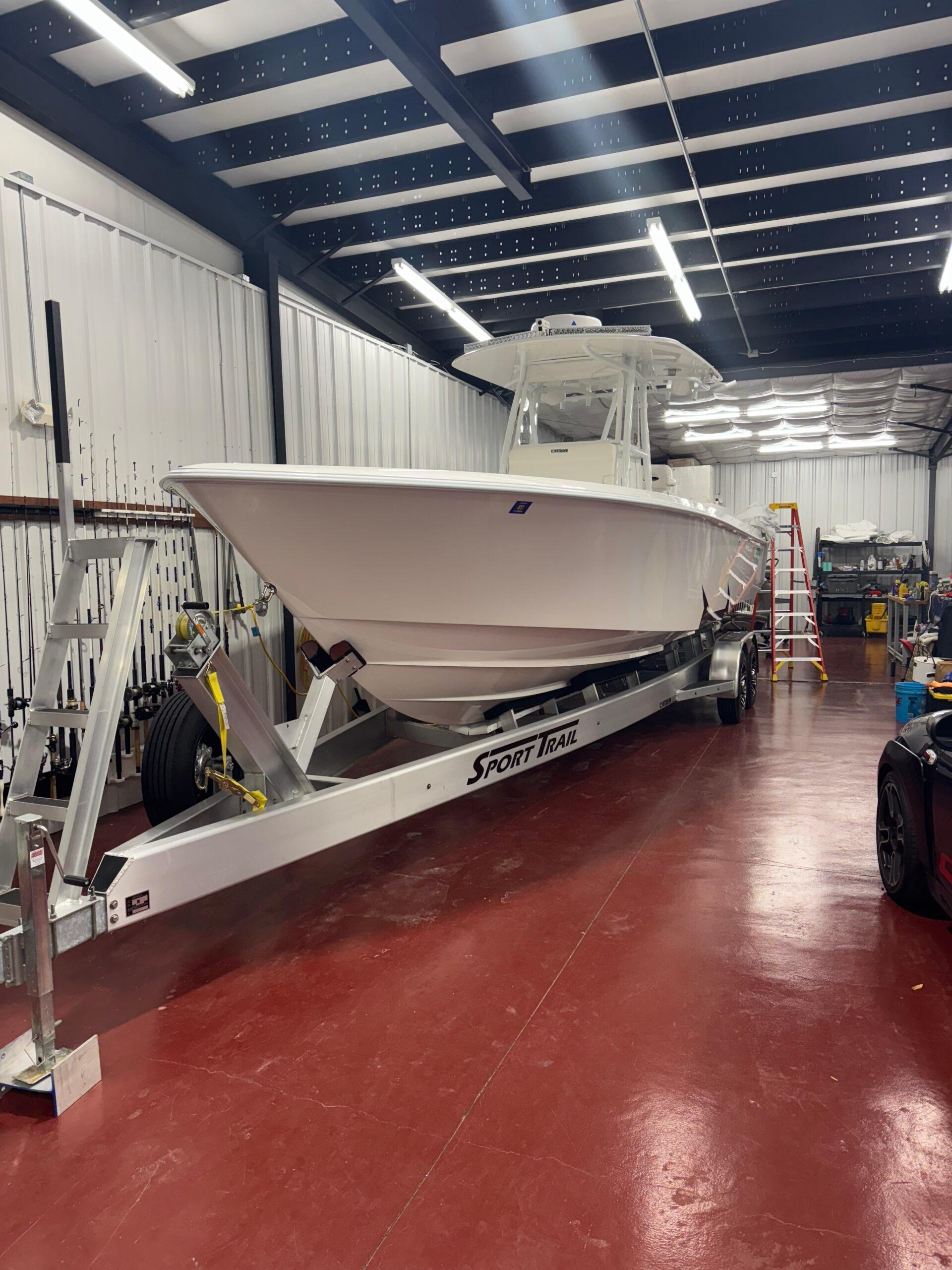 Contender 32 ST 2022 Contender 32 ST boat on trailer in a spacious indoor facility.