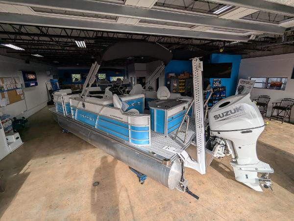 Trifecta CS 22RFC 2025 Trifecta CS 22RFC pontoon boat with Suzuki outboard motor in showroom.