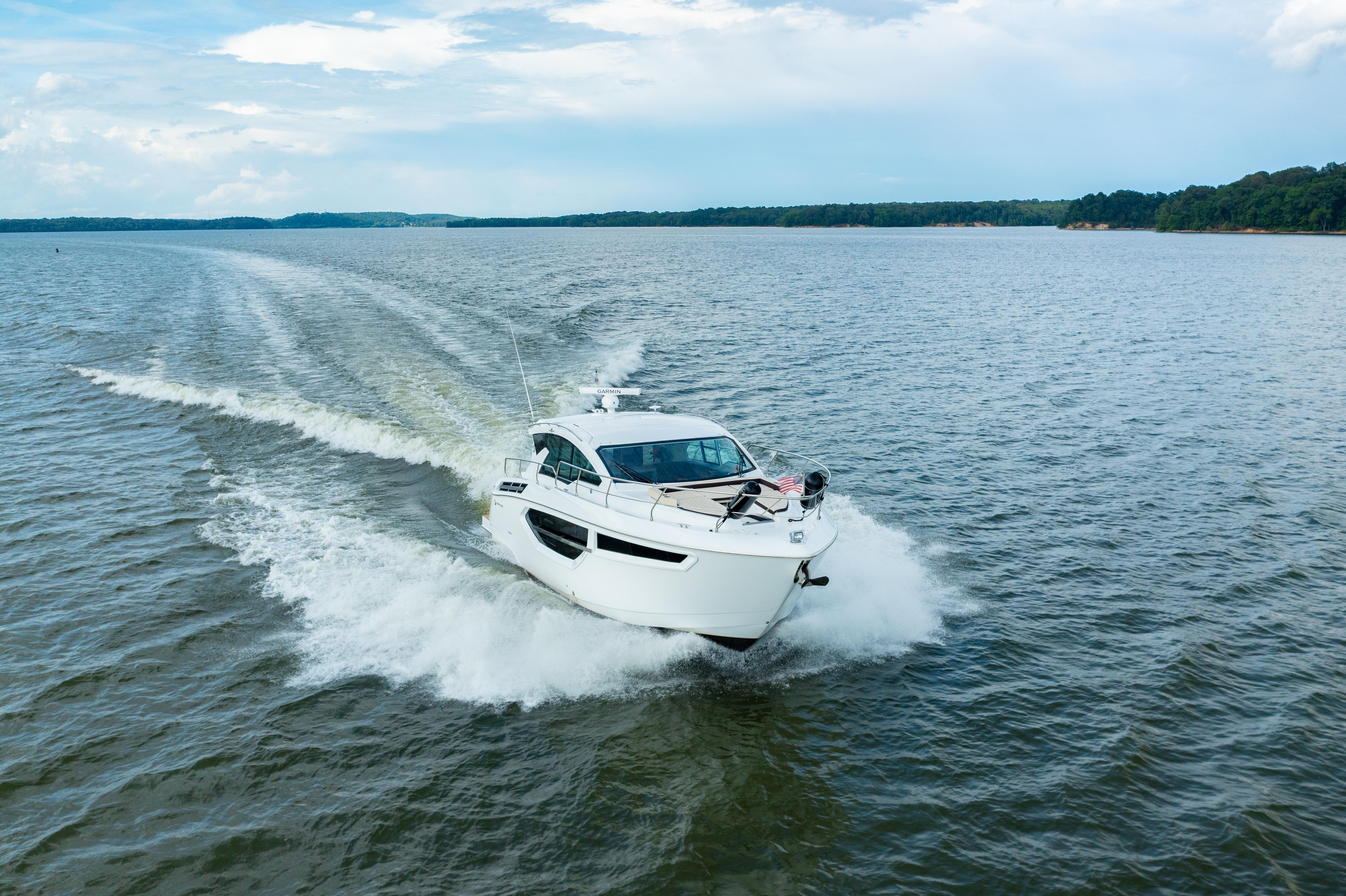 Cruisers Yachts 42 Cantius 2019 Cruisers Yachts 42 Cantius speeding on open water under a clear sky.