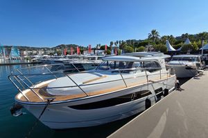 Marex 330 Scandinavia 2026 Marex 330 Scandinavia yacht docked at marina under clear blue sky.