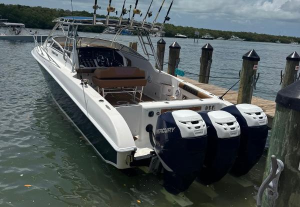 Fountain 38 LX 2006 Fountain 38 LX boat docked with triple Mercury outboard engines.
