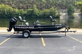 Tracker Pro 170 2024 Tracker Pro 170 boat on trailer by a scenic river.