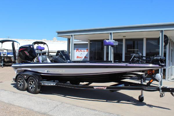 Phoenix 721 ZXL 2025 Phoenix 721 ZXL boat on trailer, parked outside a building under clear blue sky.
