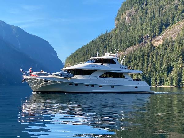 Ocean Alexander 78 Sky Lounge Ocean Alexander 78 Sky Lounge yacht cruising in a scenic mountainous waterway, 2003 model.