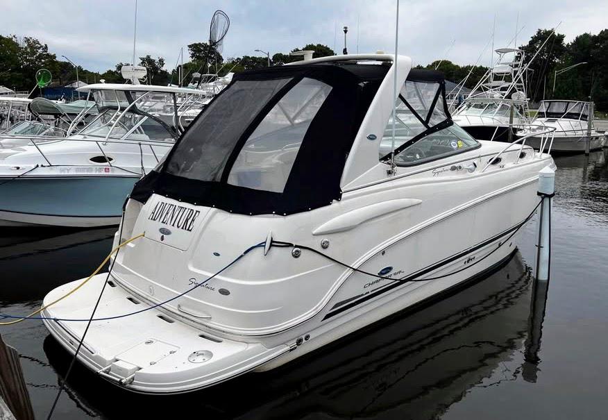 Chaparral Signature 270 2005 Chaparral Signature 270 boat docked in marina, featuring sleek design and canopy.