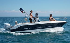 Mingolla Brava 19 2025 Mingolla Brava 19 boat cruising on open sea with two passengers.