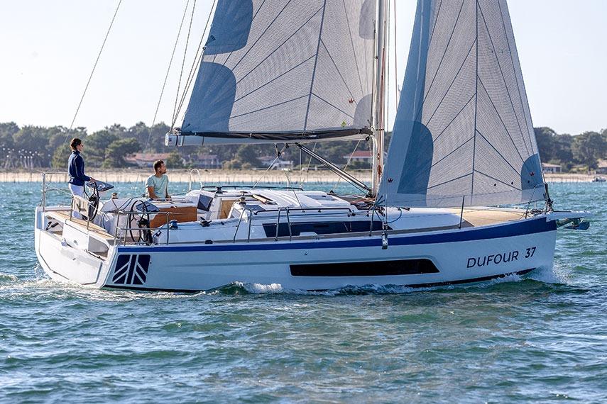 Dufour 37 2024 Dufour 37 sailboat cruising on open water with two people onboard.
