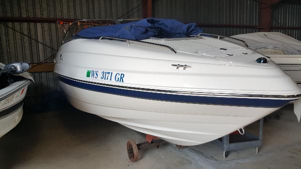 Chaparral 215 SSi 2004 Chaparral 215 SSi boat in storage, covered with a blue tarp.