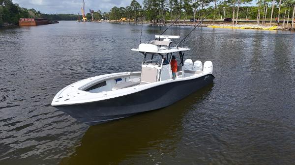 Yellowfin 34 Offshore 2022 Yellowfin 34 boat on calm river with trees in background.