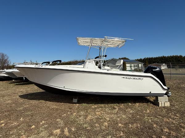 Aquasport 22CC 2023 Aquasport 22CC boat on display outdoors, featuring sleek white design.