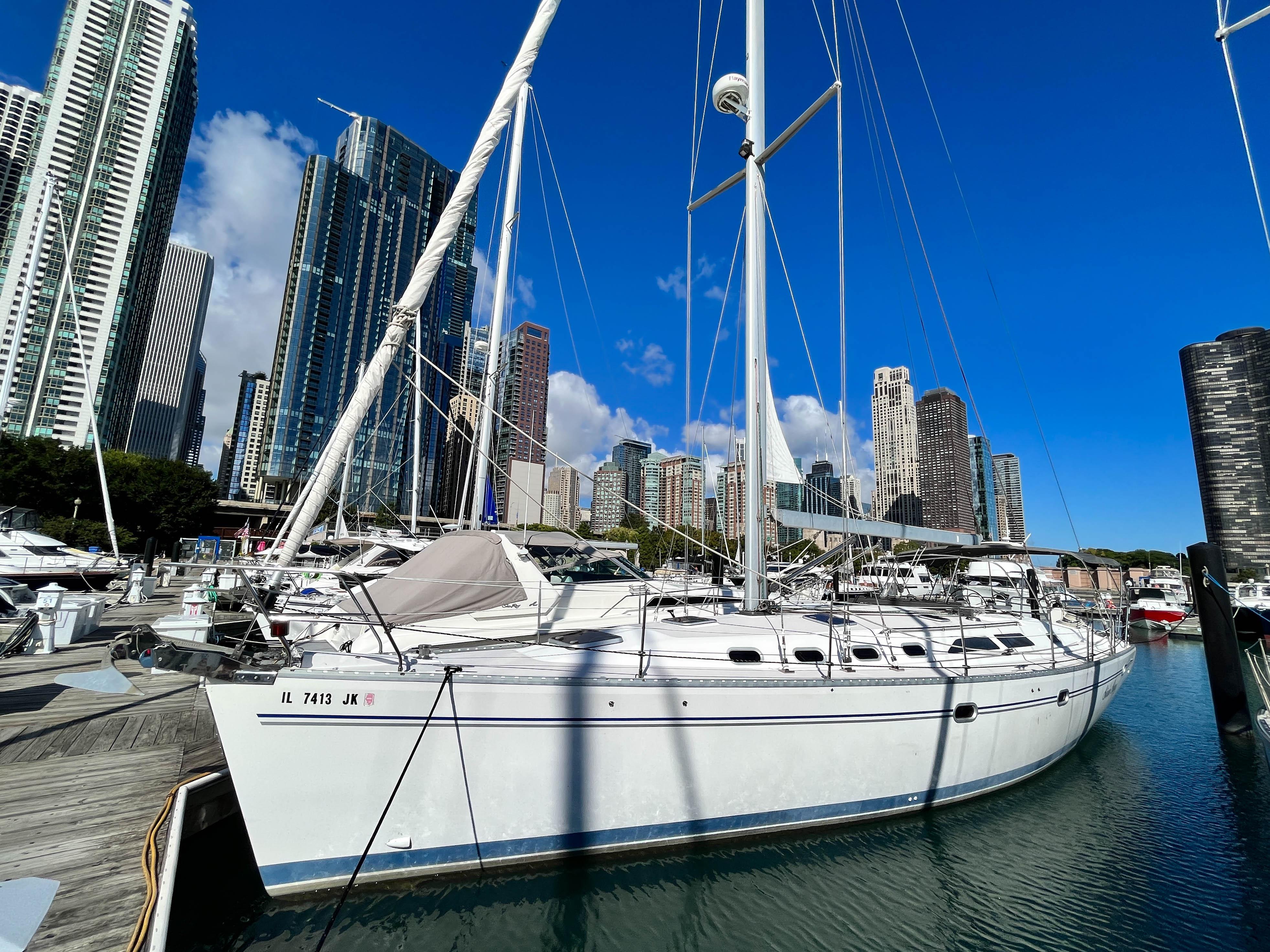 Catalina 470 2001 Catalina 470 sailboat docked in urban marina with skyscrapers in background.