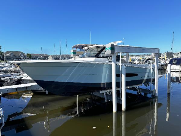 Regal 38 SAV 2025 Regal 38 SAV boat docked at a marina on a sunny day.