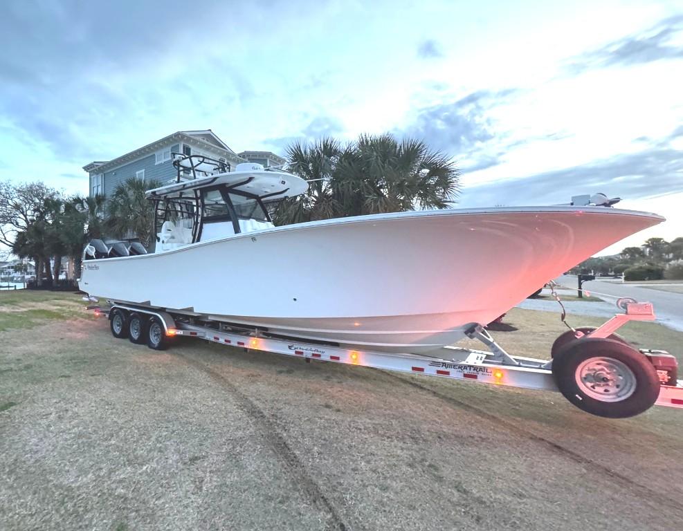 Onslow Bay 37 2024 Onslow Bay 37 boat on trailer, parked outdoors near palm trees.
