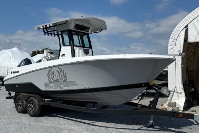 Wellcraft 243 Fisherman 2025 Wellcraft 243 Fisherman boat on trailer, parked outdoors under clear sky.