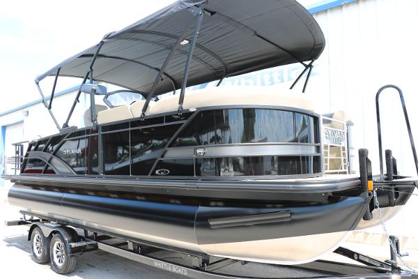 Sylvan L3 CLZ DH 2025 Sylvan L3 CLZ DH pontoon boat with black canopy on trailer.