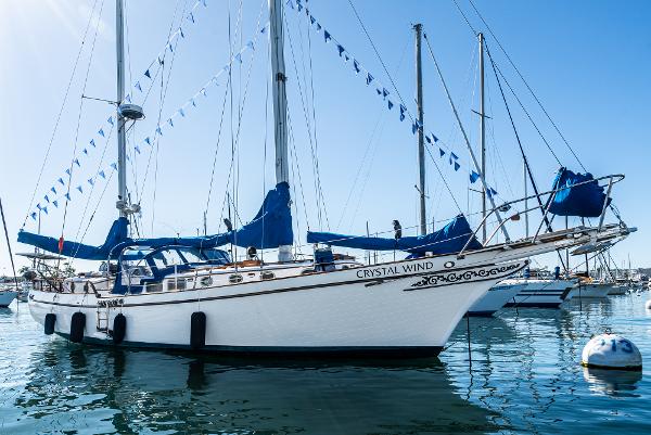 Brewer Three Seas 1977 Brewer Three Seas sailboat Crystal Wind docked in a marina.