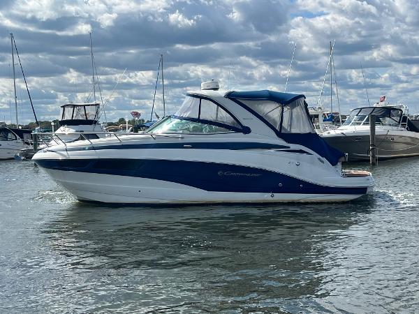Crownline 294 CR 2014 Crownline 294 CR boat on water, cloudy sky background.