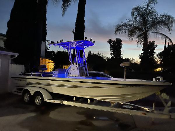 Ranger 2400 Bay Ranger 2006 Ranger 2400 Bay Ranger boat with blue lights on trailer at dusk.