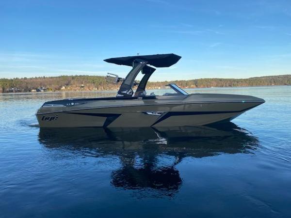 Tigé 24 RZX 2023 Tigé 24 RZX boat on calm lake with clear sky.