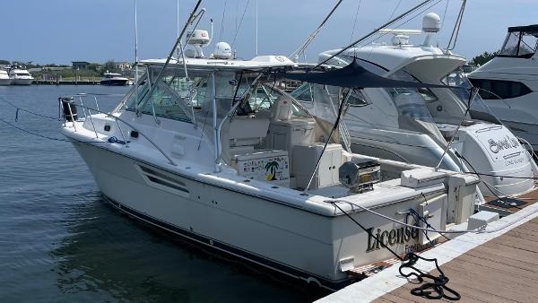 Pursuit 3400 Express 2002 Pursuit 3400 Express Cruiser docked at marina, side view.