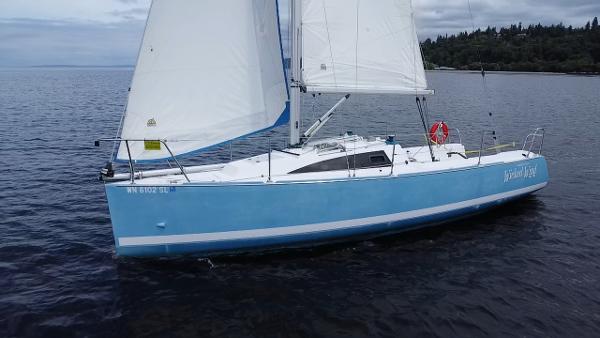 Catalina 275 Sport 2015 Catalina 275 Sport sailboat on calm water, featuring a sleek blue hull and white sails.