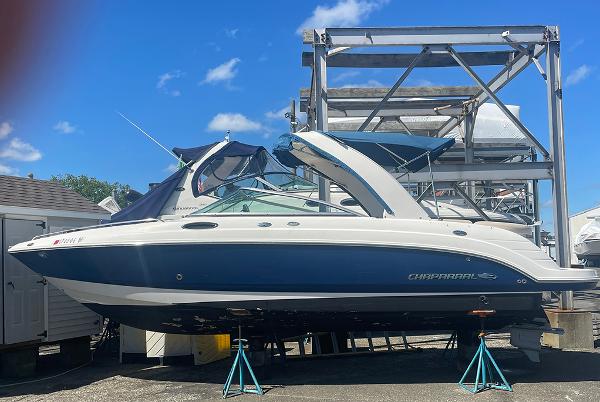 Chaparral 256 SSi 2007 Chaparral 256 SSi boat on stands in a marina storage area.