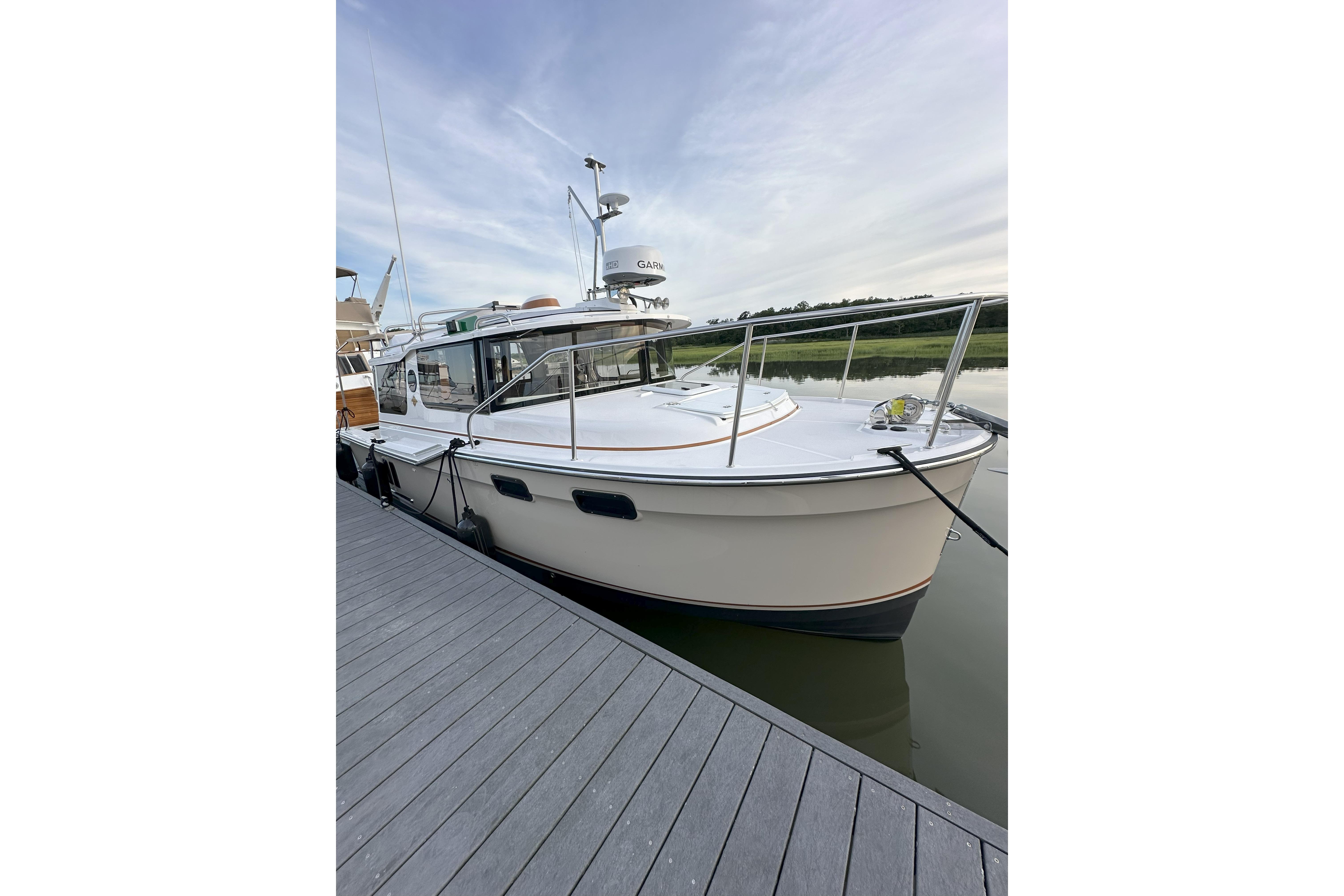 Ranger Tugs R-27 2023 Ranger Tugs R-27 docked, showcasing sleek design and modern features.