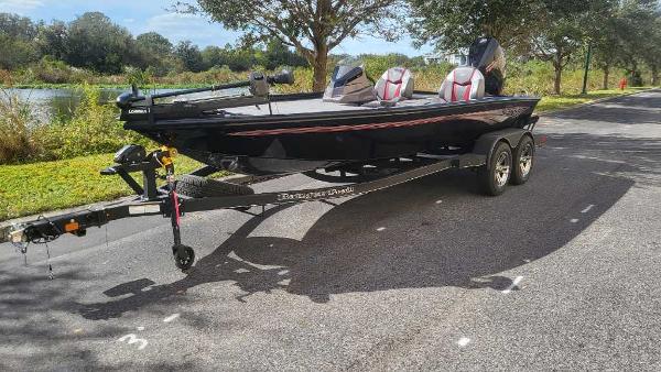 Ranger ALPHA 208 2025 Ranger ALPHA 208 boat on trailer, parked on a sunny road.