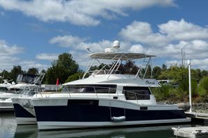 Fountaine Pajot Summerland 40 LC 2015 Fountaine Pajot Summerland 40 LC catamaran docked under a blue sky.