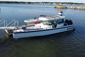 Axopar 28 Cabin with AFT CABIN 2022 Axopar 28 Cabin with AFT CABIN docked in a serene marina setting.