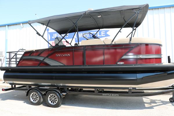 Sylvan L3 CLZ DH 2025 Sylvan L3 CLZ DH pontoon boat with red and black design on trailer.