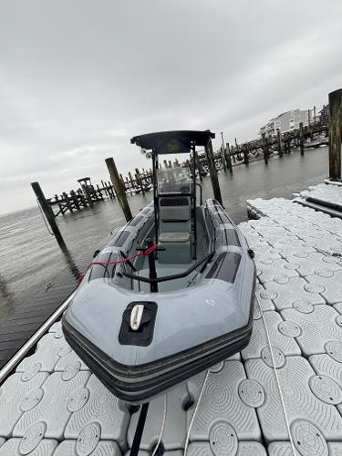 Zodiac Pro 650 2017 Zodiac Pro 650 boat docked on a floating platform, overcast sky.