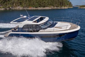 Marex 440 Scandinavia 2026 Marex 440 Scandinavia cruising on a scenic waterway with lush forested backdrop.