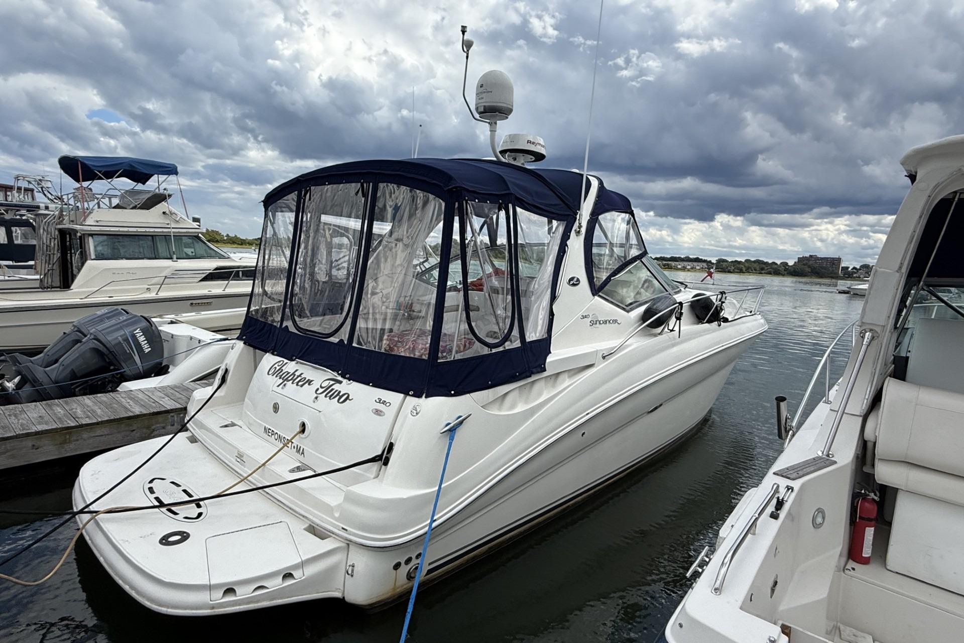 Sea Ray 320 Sundancer 2007 Sea Ray 320 Sundancer docked at marina under cloudy skies.