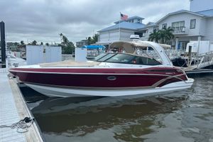 Formula 330 Crossover Bowrider 2016 Formula 330 Crossover Bowrider docked at marina, overcast sky.