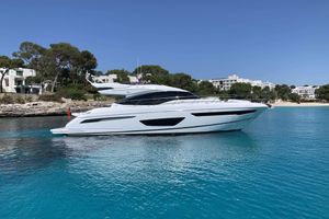 Princess S65 Luxury 2017 Princess S65 yacht cruising in clear blue waters near a scenic coastline.