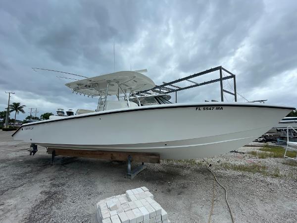 Venture 34 Tournament 2000 Venture 34 Tournament boat on dry land under cloudy skies.