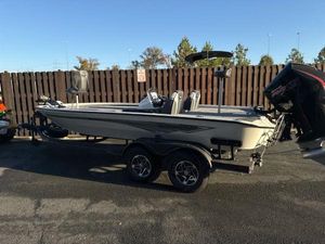 Ranger ALPHA 208 2025 Ranger ALPHA 208 boat on trailer, parked outdoors, with outboard motor.