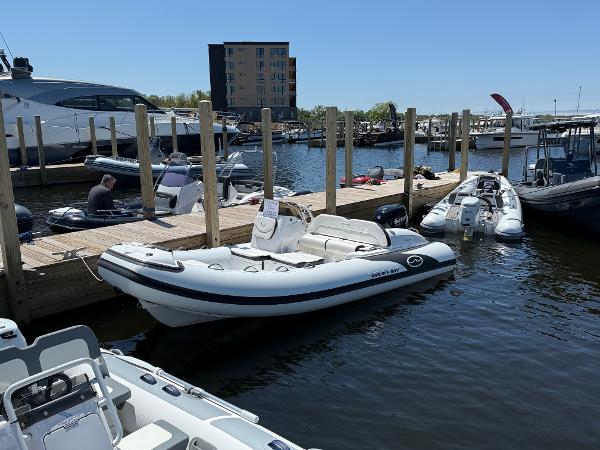 Walker Bay Venture 16 2024 Walker Bay Venture 16 boat docked at a marina on a sunny day.