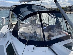 Hunter Passage 420 2000 Hunter Passage 420 sailboat with blue canopy, docked in a sunny marina.
