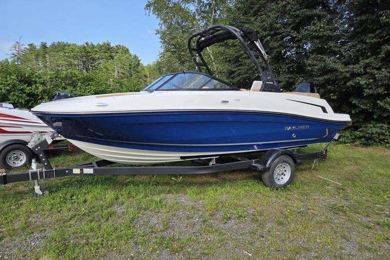 Bayliner VR5 Bowrider OB 2025 Bayliner VR5 OB boat on trailer, blue and white, parked outdoors.