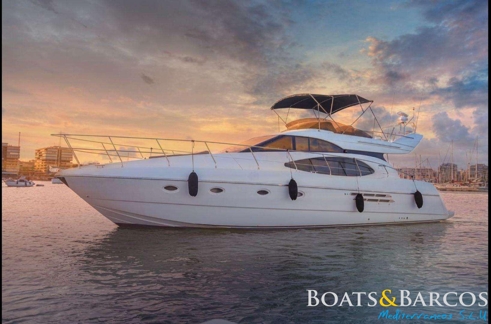 Azimut 52 - 1997 Luxury Azimut 52 yacht from 1997 on calm waters at sunset.