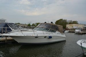 Cruisers Yachts 3120 Aria 1997 Cruisers Yachts 3120 Aria docked at marina, overcast sky.