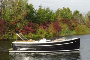 Antaris Antaris Seventy7 Sport 2015 Antaris Seventy7 Sport boat cruising on a scenic river with lush greenery.