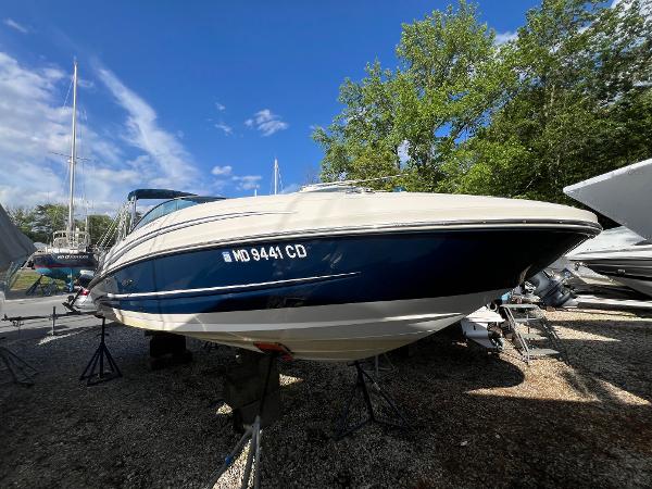 Sea Ray 240 Sundeck 2012 Sea Ray 240 Sundeck boat on display, surrounded by trees and other boats.