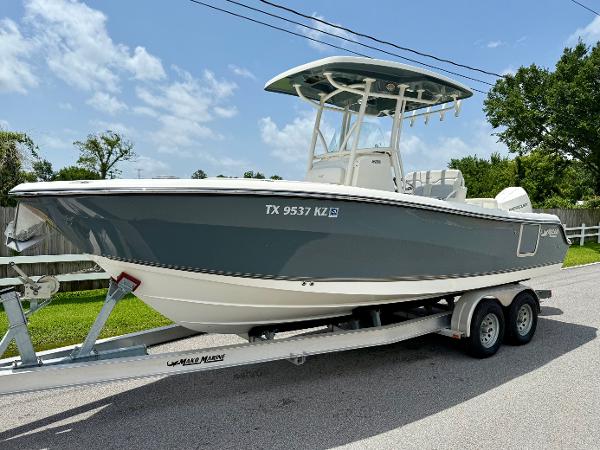 Mako 236 CC 2020 Mako 236 CC boat on trailer, parked on a sunny street.