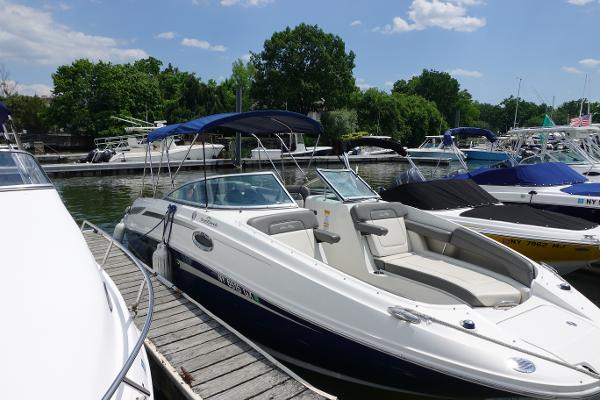 Sea Ray 260 Sundeck 2011 Sea Ray 260 Sundeck boat docked at marina, surrounded by other boats.