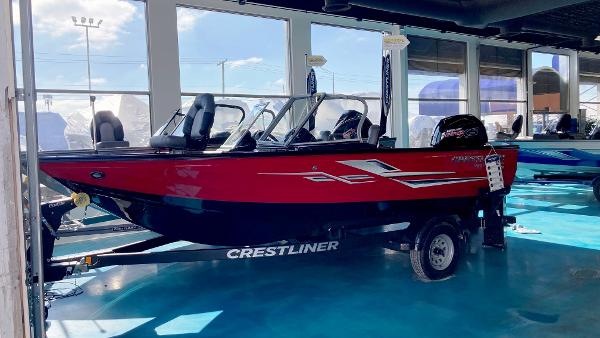 Crestliner 1750 Super Hawk 2023 Crestliner 1750 Super Hawk boat in showroom, red exterior, on trailer.