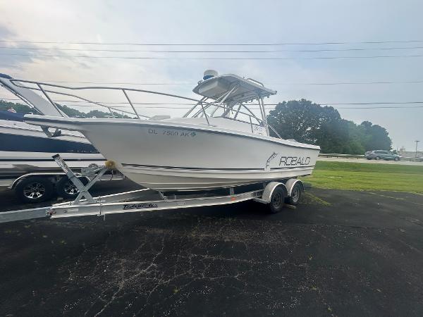 Robalo 2140 Walkaround 1997 Robalo 2140 Walkaround boat on trailer, parked outdoors.