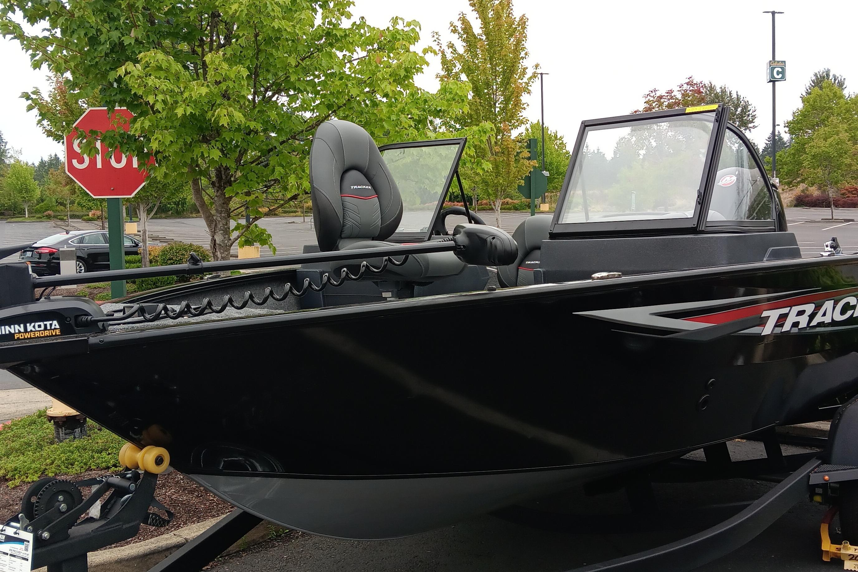 Tracker Pro Guide V-175 WT 2026 Tracker Pro Guide V-175 WT boat parked near trees and stop sign.